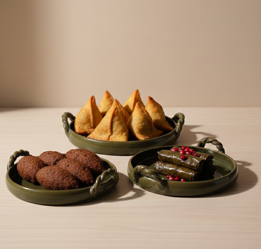 Three green ceramic plates with food on a beige background, featuring the brand 'fovere'.